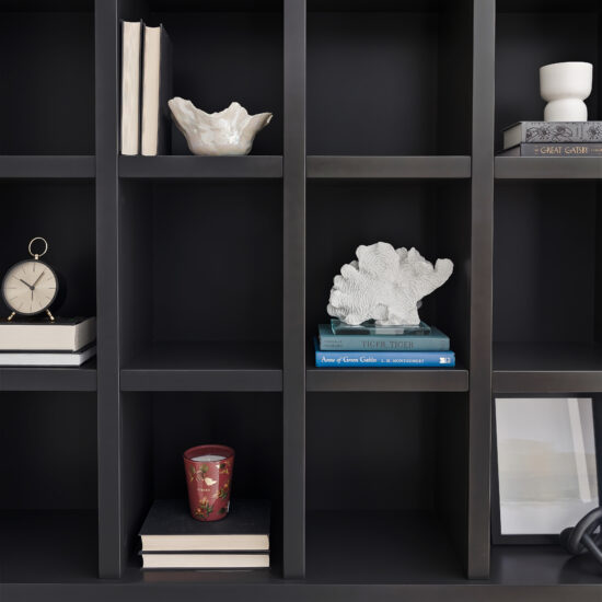 Custom black built-in shelving with books and decorative elements in a modern home office in Durham Region.