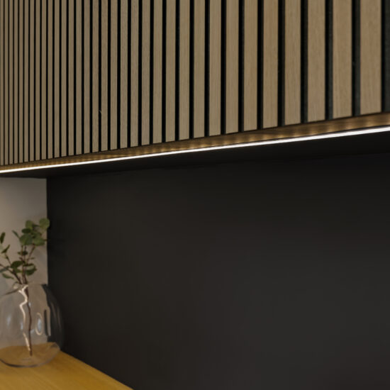 Close-up of a modern office cabinet with warm LED underlighting, a black backsplash, and a minimalist glass vase in Whitby.