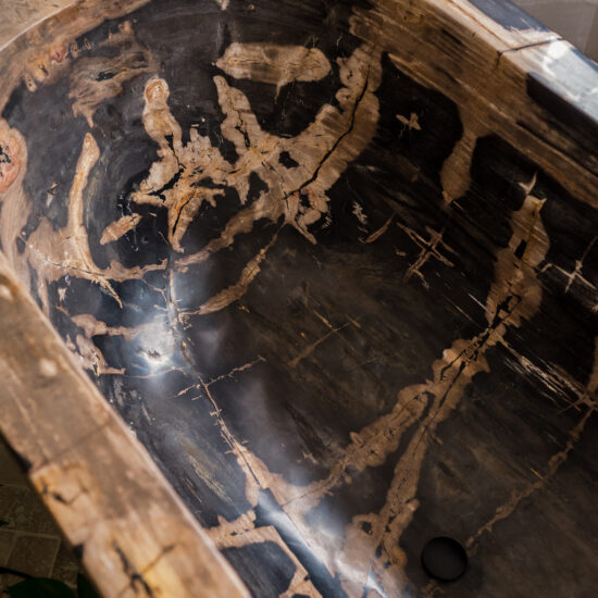 Close-up view of a stunning petrified wood bathtub in Whitby, Ontario, showcasing its unique natural patterns and luxurious craftsmanship.